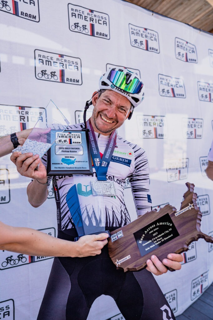 Da freut sich einer über zehn Kilo Trophäe: Sieger Philipp Kaider beim Race Across America 2025.